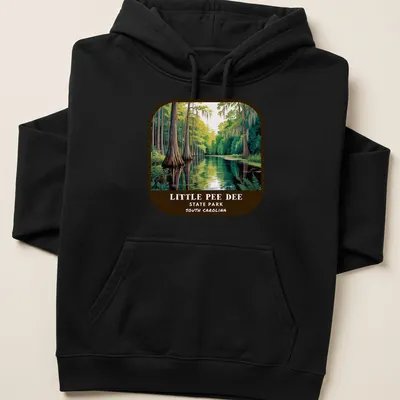 Vintage illustration of swamp landscape with cypress trees and text for Little Pee Dee State Park — printed on a unisex hoodie