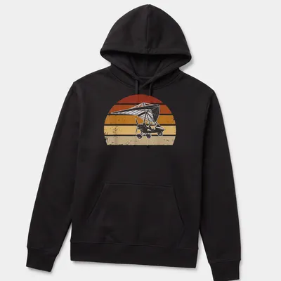 Retro distressed microlight aircraft flying against a colorful sunset — printed on a unisex hoodie