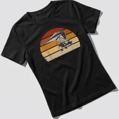 Retro distressed microlight aircraft flying against a colorful sunset — printed on a women's shirt