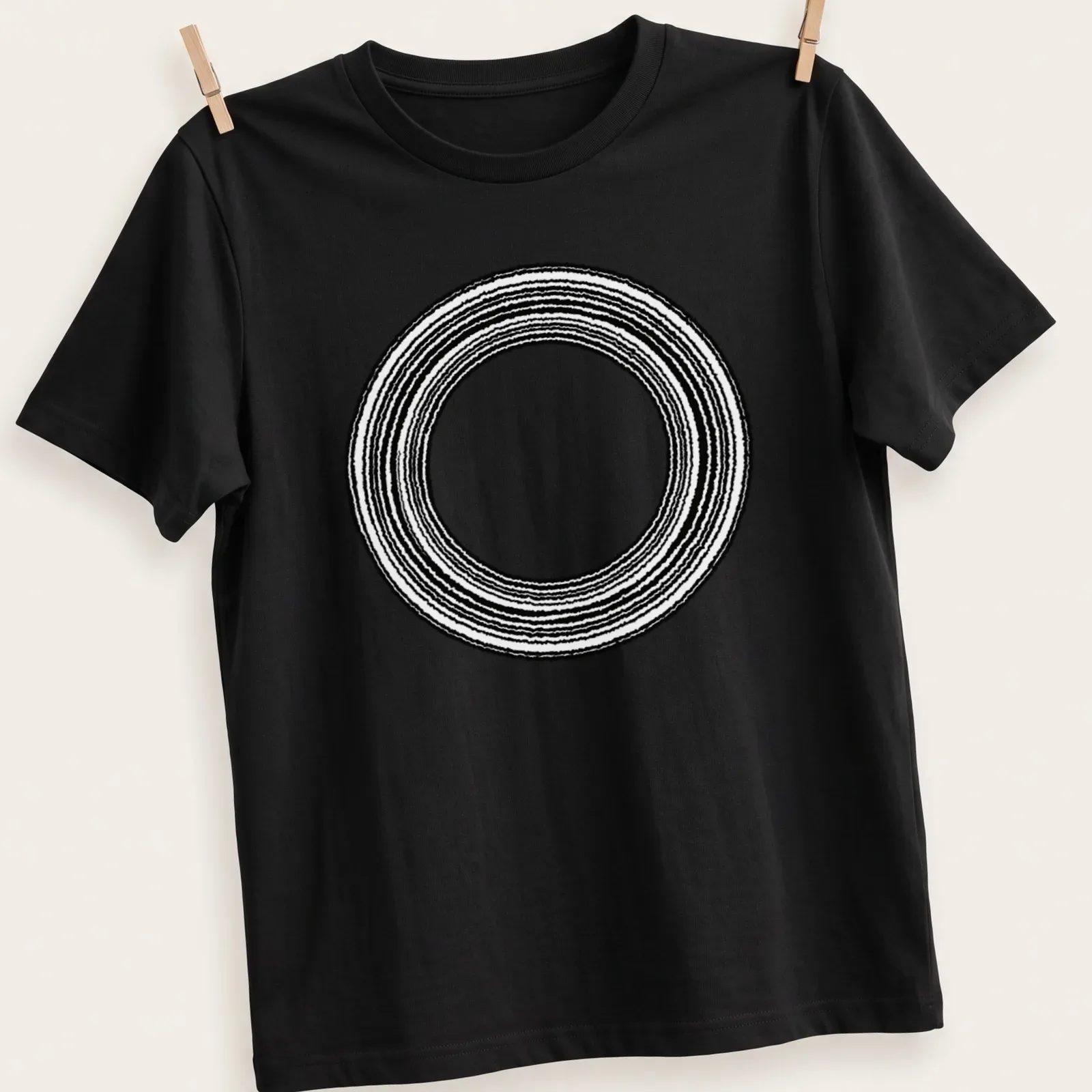 Minimalist design featuring concentric rings in black and white — printed on a unisex t-shirt