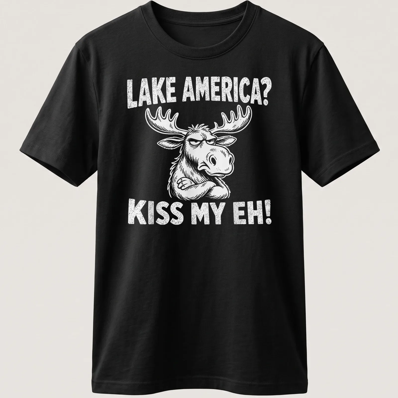 Cartoon moose graphic with the text 'LAKE AMERICA? KISS MY EH!' in black and white — printed on a unisex t-shirt