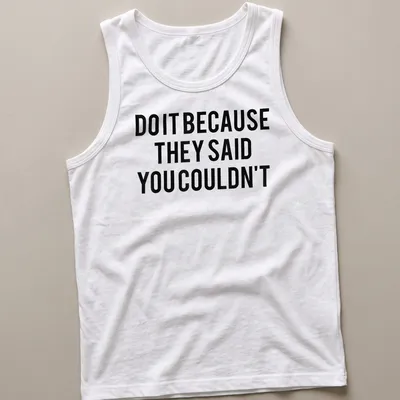 Bold typography shirt with the motivational quote 'DO IT BECAUSE THEY SAID YOU COULDN'T' in black and white — printed on a tank top