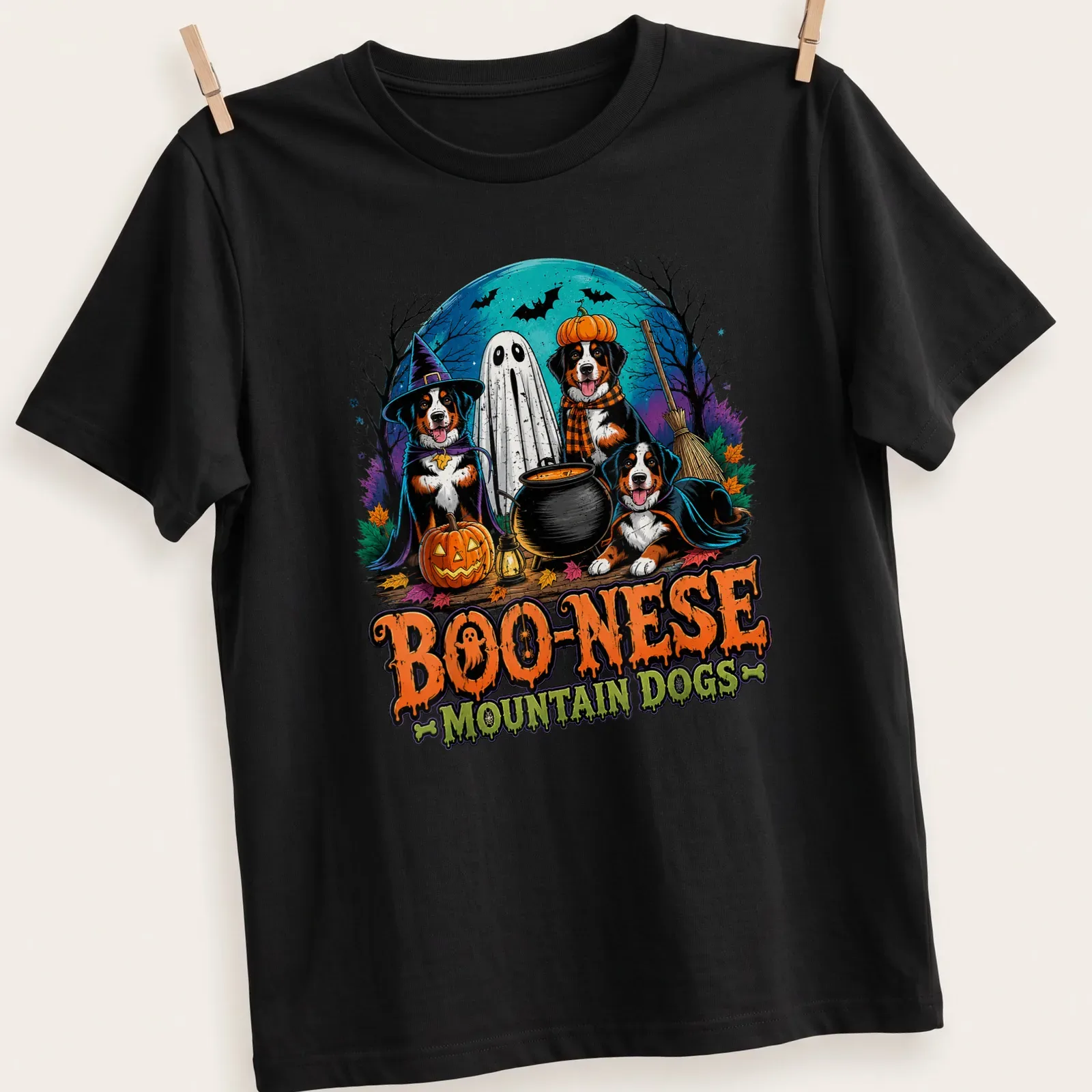 Colorful Halloween illustration of Mountain Dogs in witch costumes with pumpkins — printed on a unisex t-shirt
