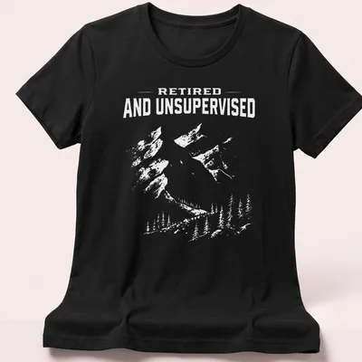 Vintage distressed tee featuring mountains and the phrase Retired And Unsupervised — printed on a women's shirt