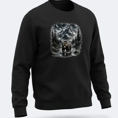 Realistic brown bear in a mountain wilderness scene with blue sky — printed on a unisex sweatshirt