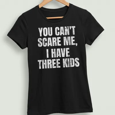 Vintage distressed tee with humorous text about parenting three kids — printed on a women's shirt