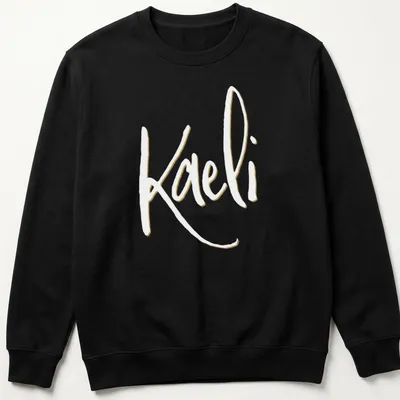 Elegant script personalized name T-shirt featuring 'Kaeli' in gold and white — printed on a unisex sweatshirt