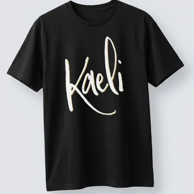 Elegant script personalized name T-shirt featuring 'Kaeli' in gold and white