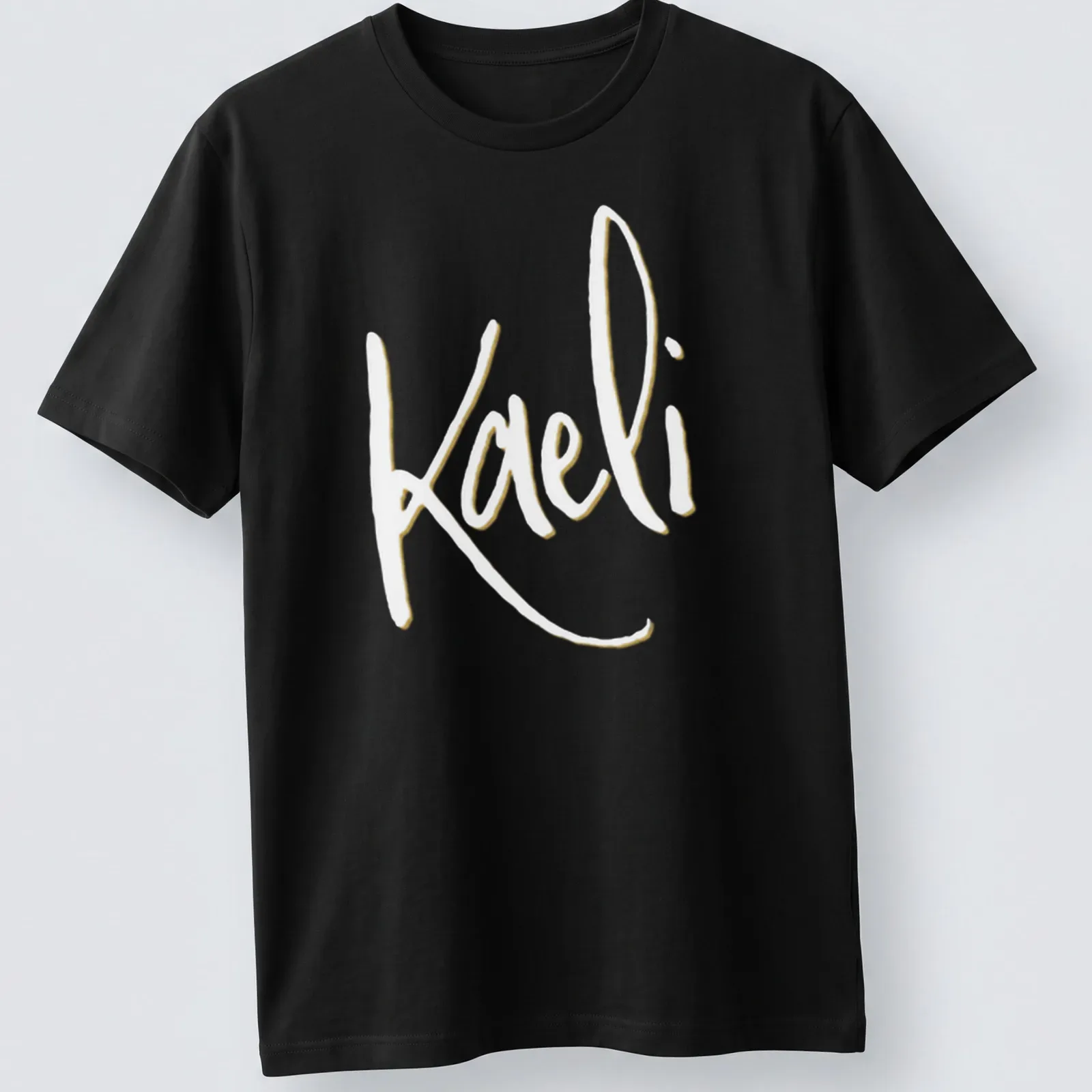 Elegant script personalized name T-shirt featuring 'Kaeli' in gold and white — printed on a unisex t-shirt