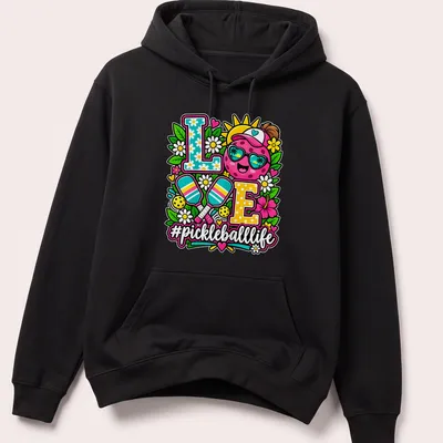 Colorful illustration of a smiling pickleball with sunglasses and text '#pickleballlife' — printed on a unisex hoodie