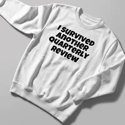 Bold black text says I Survived Another Quarterly Review on a — printed on a unisex sweatshirt