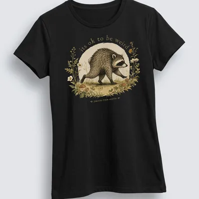 Cottagecore Raccoon t-shirt with whimsical design featuring the phrase about being weird — printed on a women's shirt
