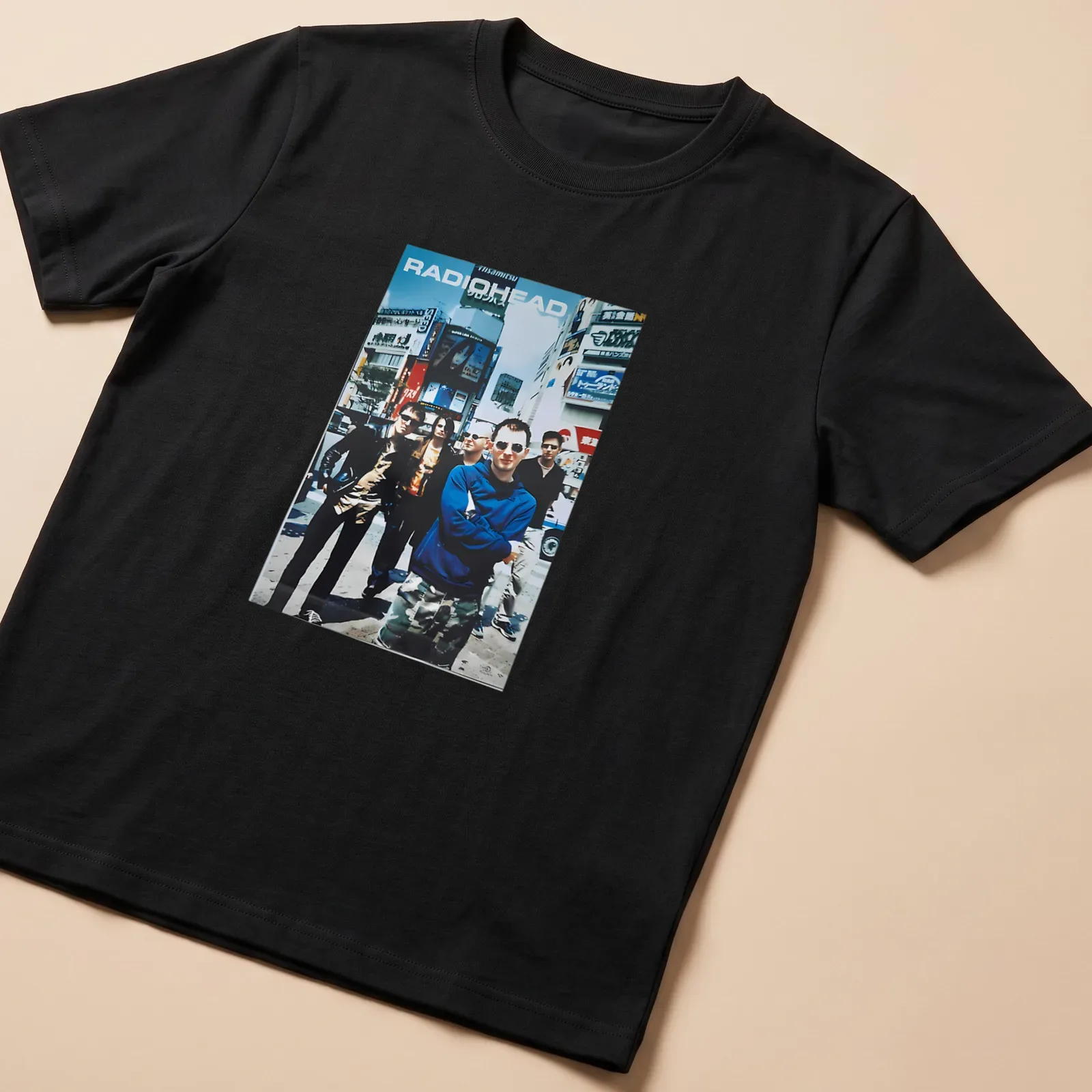 Vintage Radiohead band photo t-shirt in blue, black, white, and grey — printed on a unisex t-shirt