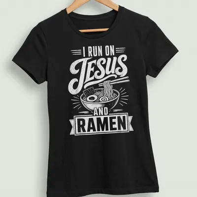 Retro distressed t-shirt featuring a ramen bowl and the text I RUN ON JESUS AND RAMEN — printed on a women's shirt