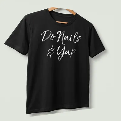 Handwritten script t-shirt featuring 'Do Nails & Yap' for beauticians — printed on a unisex t-shirt (angled view)