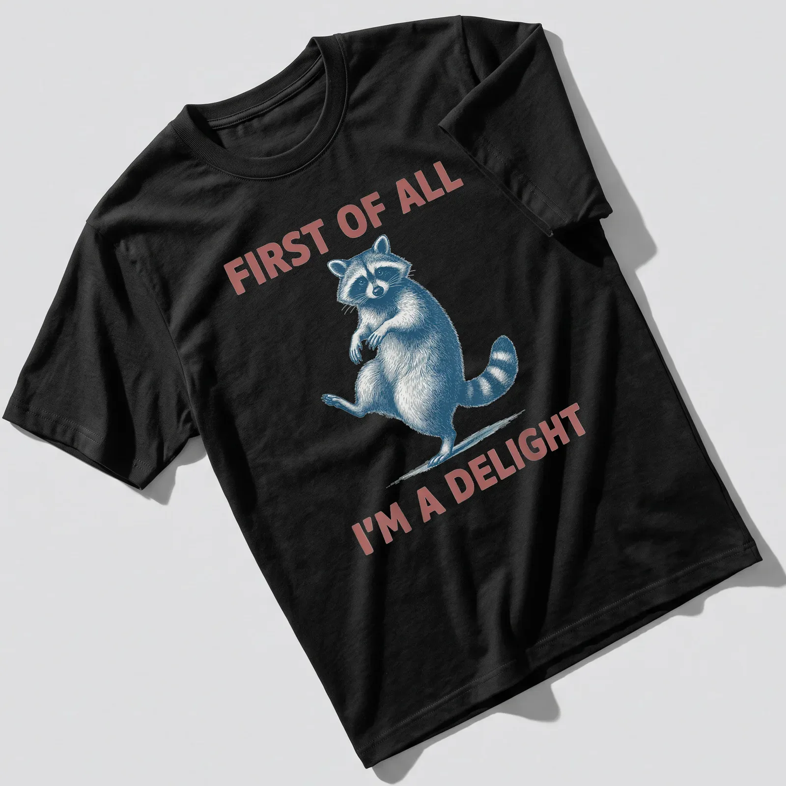 Vintage illustrated sassy raccoon with the text 'First Of All I'm A Delight' — printed on a unisex t-shirt