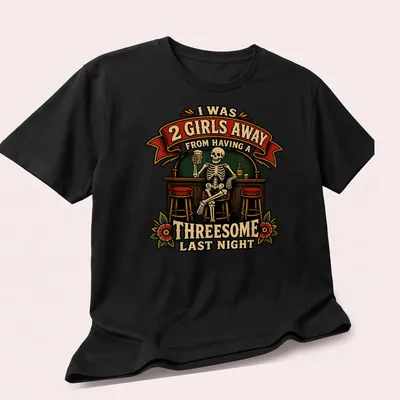 Vintage bar illustration with skeleton and humorous text about a threesome — printed on a unisex t-shirt (angled view)