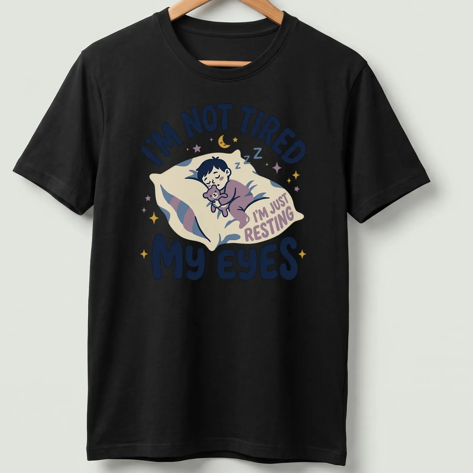 Kawaii illustration of a sleepy boy with a teddy bear and playful text — printed on a unisex t-shirt