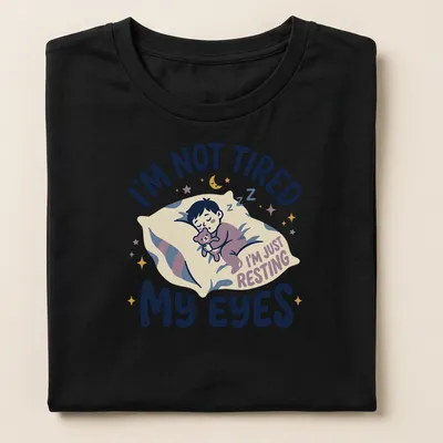 Kawaii illustration of a sleepy boy with a teddy bear and playful text — printed on a women's shirt