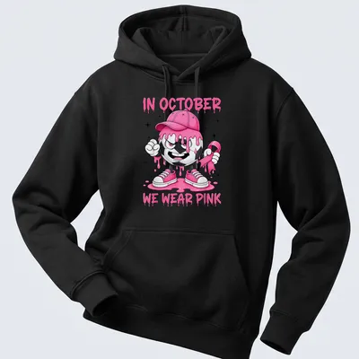 Kawaii soccer ball character design with the text 'In October We Wear Pink' — printed on a unisex hoodie