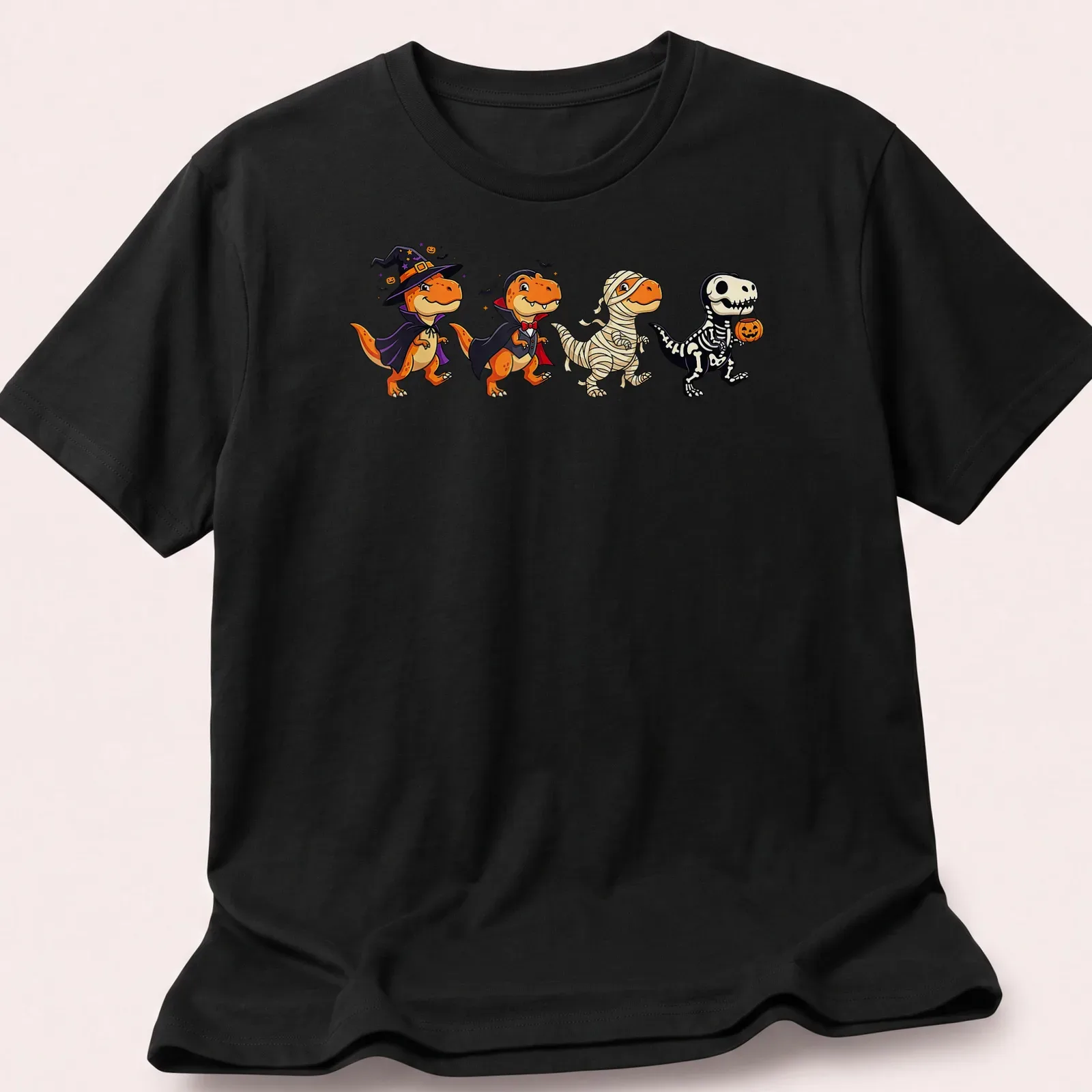 Kawaii T Rex dressed as a witch and vampire for Halloween in orange, black, purple, and white — printed on a unisex t-shirt