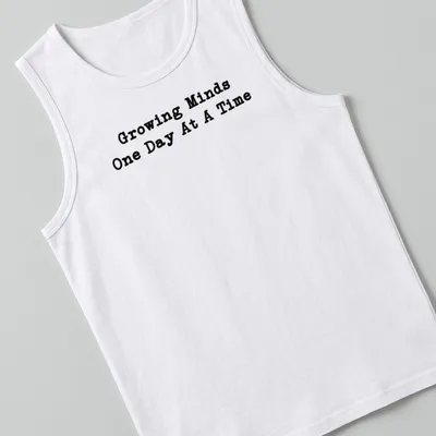 Bold typography Teacher shirt with the phrase Growing Minds One Day At A Time in black — printed on a tank top