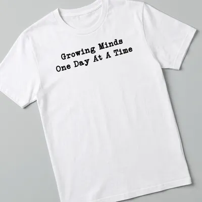 Bold typography Teacher shirt with the phrase Growing Minds One Day At A Time in black