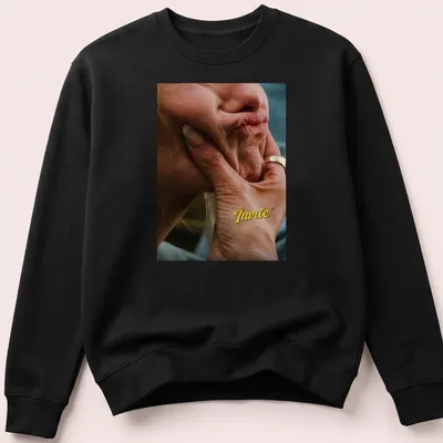 Photographic tee featuring a hand holding a thoughtful face with text "The Invite" above. — printed on a unisex sweatshirt