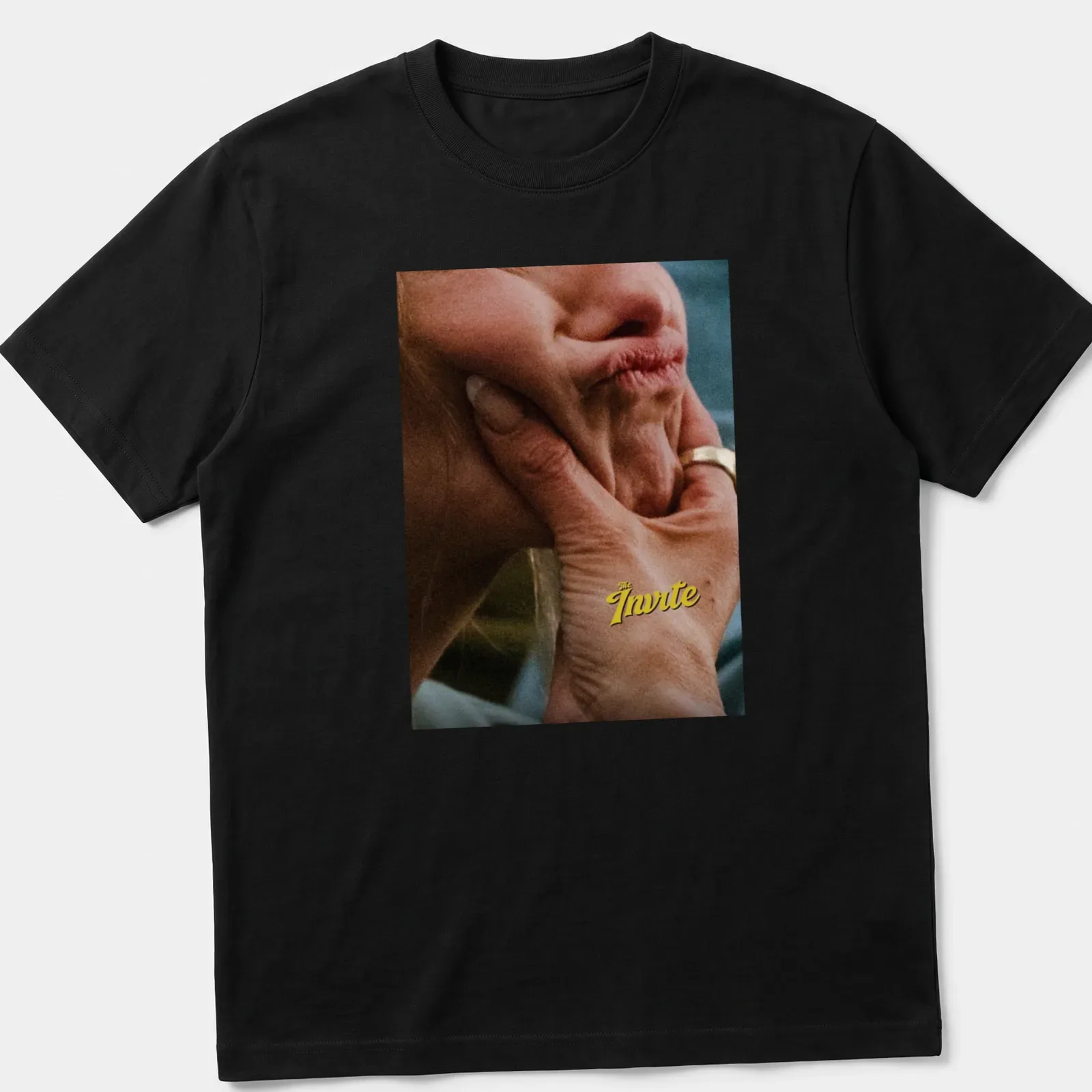 Photographic tee featuring a hand holding a thoughtful face with text "The Invite" above. — printed on a unisex t-shirt