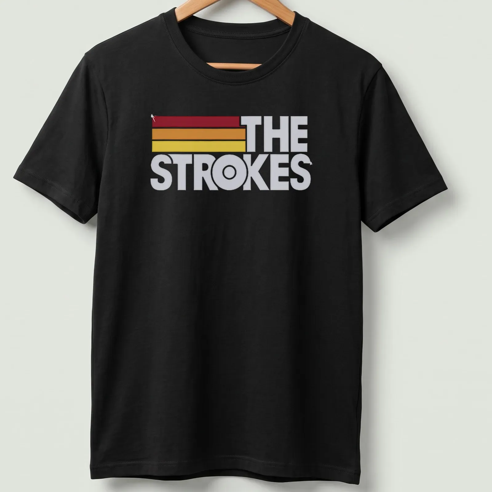 The Strokes logo in retro colors of red, orange, yellow, and white. — printed on a unisex t-shirt