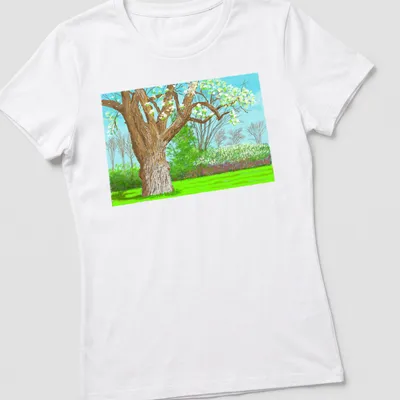 Colorful illustrative tree landscape with green leaves and blue sky — printed on a women's shirt