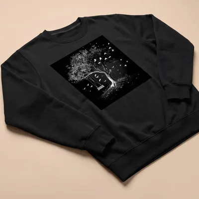 Black and white illustration of a tree with a swing and flying birds. — printed on a unisex sweatshirt