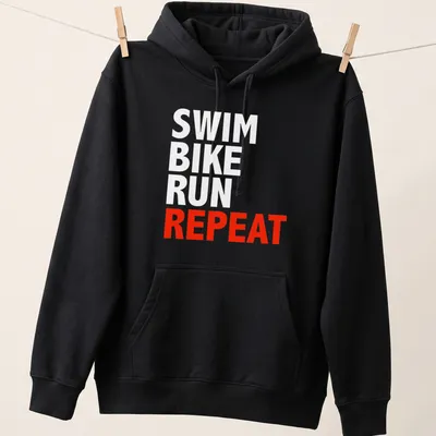 Bold typography t-shirt featuring the word REPEAT, representing triathlon training. — printed on a unisex hoodie