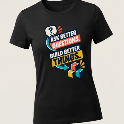 Colorful building blocks surrounding the text 'Ask Better Questions. Build Better Things.' — printed on a women's shirt