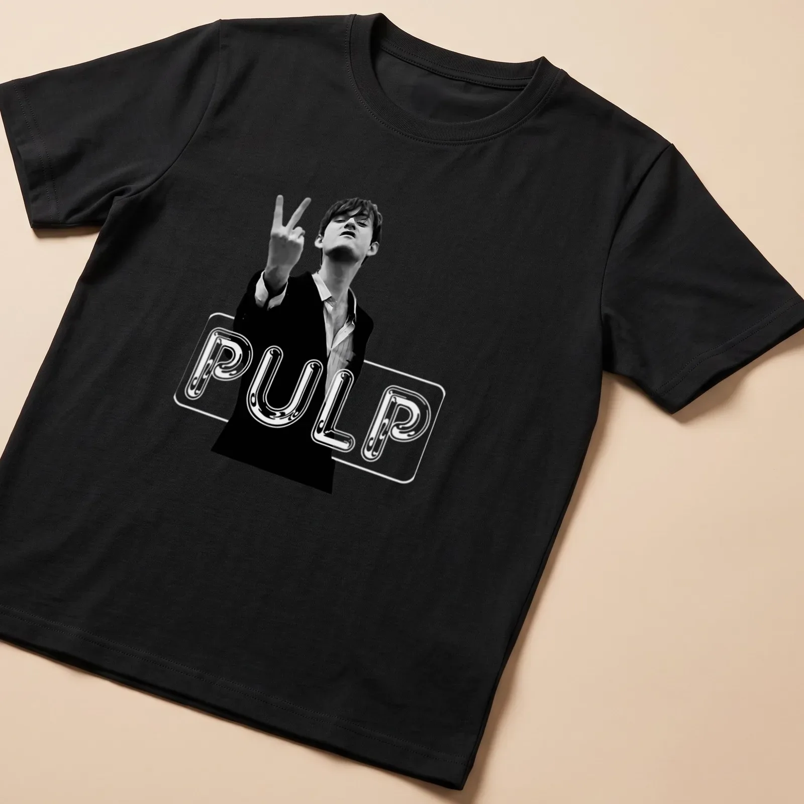 Black and white graphic of a man in a suit making a victory sign with PULP text — printed on a unisex t-shirt