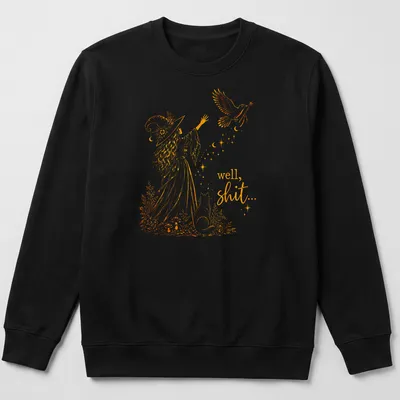 Illustrative line-art of a witch with a crow and a magic wand alongside the text 'well, shit...' — printed on a unisex sweatshirt