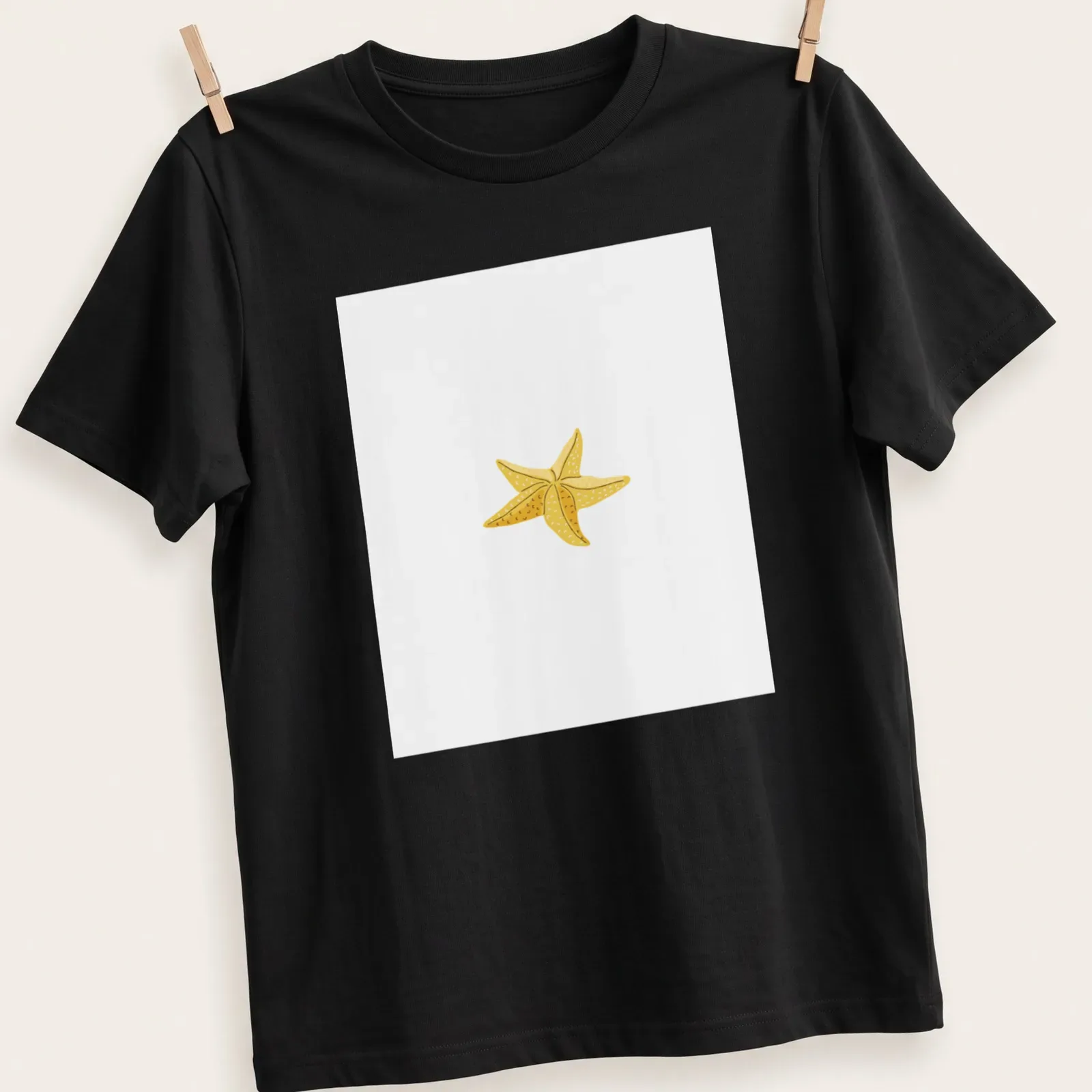 Simple illustration of a yellow starfish on a white background — printed on a unisex t-shirt